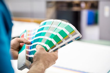 Man Hands with Color Samples at Printing Press